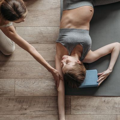 A simple yoga block placed neatly on a mat.
